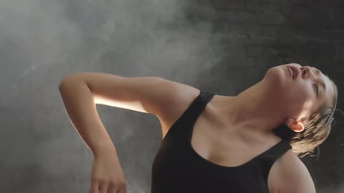 Young Woman Doing Contemporary Dance in Smoke