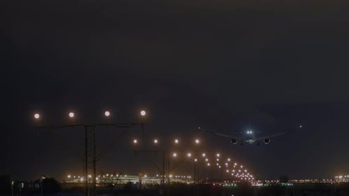 Airplane Landing at Night with Glowing Runway Lights