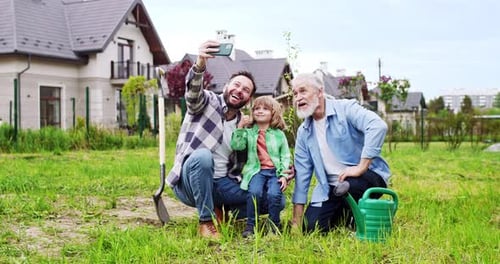 Three Generations Posing for a Cheerful Selfie