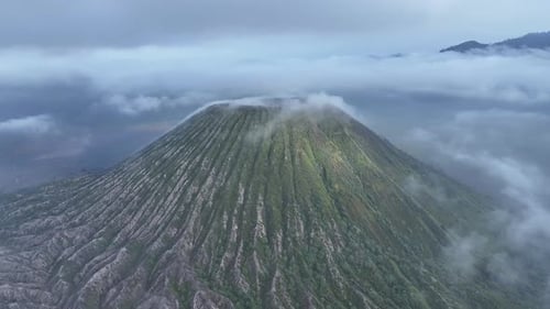 aerial view flying to mount Bromo active volcano above sea of clouds, Java, Indonesia