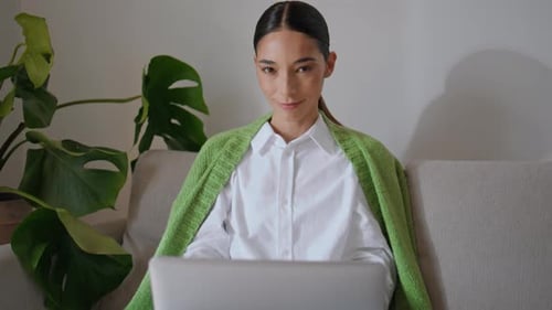 Woman Working on Laptop at Home