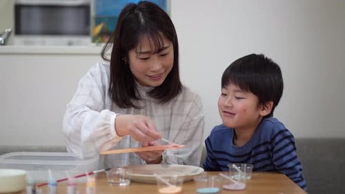 Woman and Child Crafting Together at Home