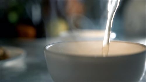Hot Broth Poured into Bowl Close Up