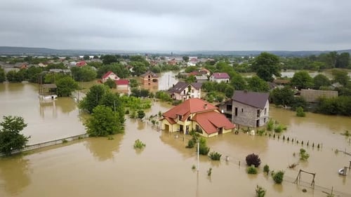 Aerial View of Flooded House with Dirty Water All Around It