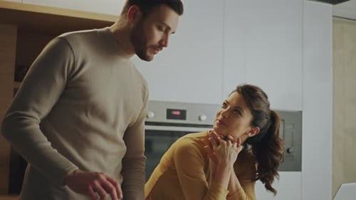 Couple preparing meal in kitchen