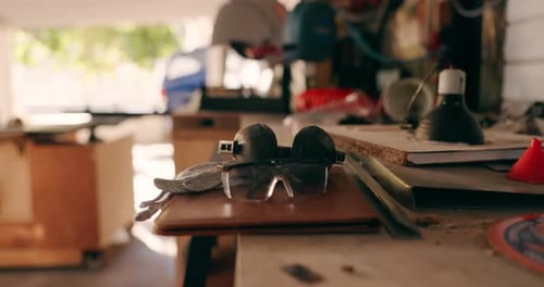 Safety goggles, table and wood tools for carpentry, construction and building in workshop