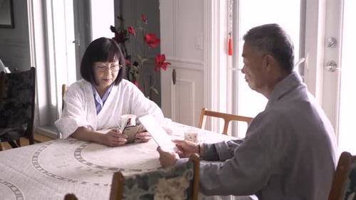 Senior Couple Sharing Moments with Tablet and Paper