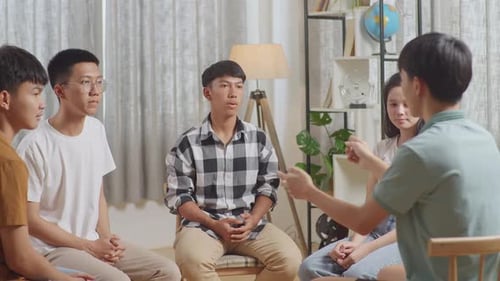 Asian Teen Group Sitting, Back View Of A Boy In Gray Shirt Motivating His Friends, Coaching