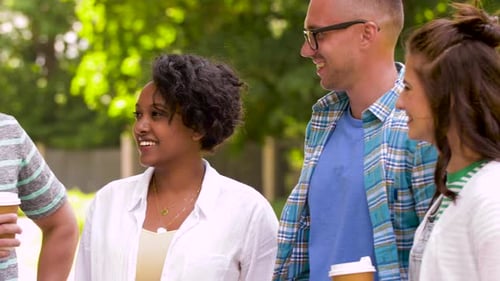 Young Adults Chatting and Drinking Coffee Outdoors