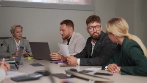 Business Meeting Around Conference Table with Four Adults