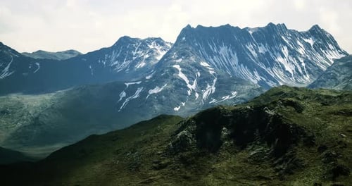 Majestic Mountain Landscape with Snow Capped Peaks in Bright Daylight