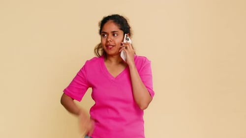 Indian Woman Holding Smartphone to Ear Smiling Cheerfully During Pleasant Friendly Phone Call