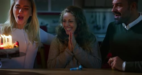 Friends Celebrating Birthday Together with Cake and Candles