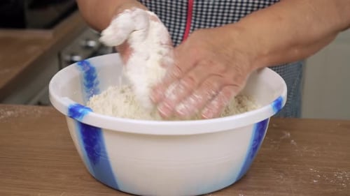 Woman Preparing Dough in Bowl Inside Home Kitchen