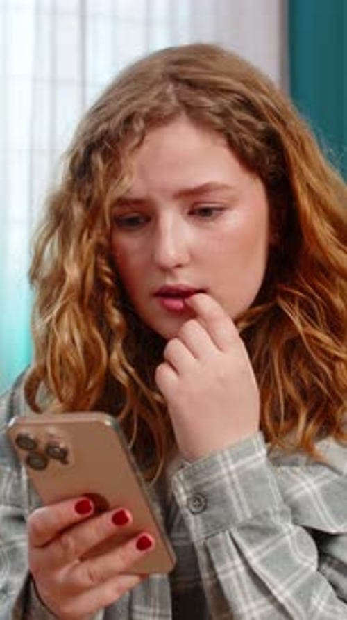 Worried Woman Using Phone Indoors