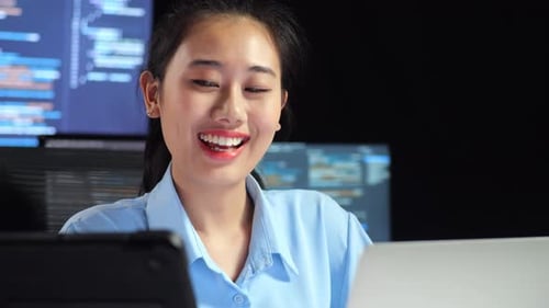 Happy Woman Working at Computer in Dark Office