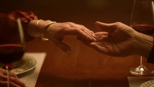 Senior Couple Tender Touch at Dinner