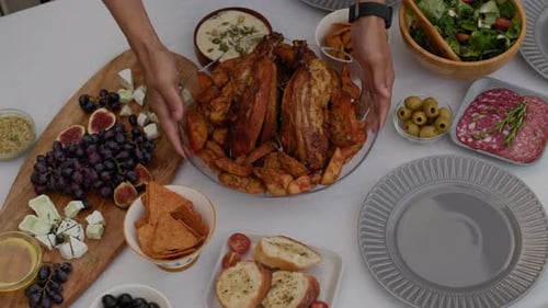 Serving Turkey in Middle of Dinner Table on Thanksgiving Day