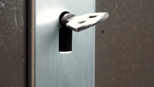 Key Hole In Old Wooden Door With Key