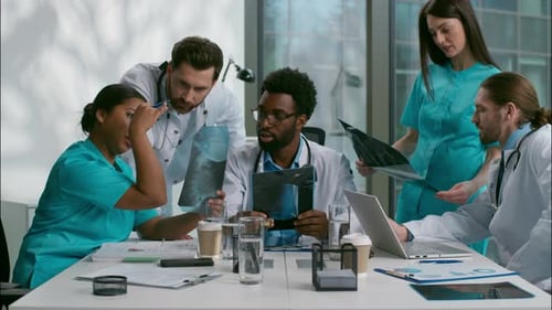 Doctors Discussing X-Rays in Modern Office