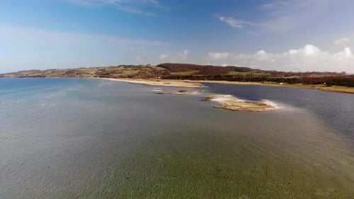 Aerial view flying across the sea in Sejerøbugten with swimming and flying seabirds and beautiful sa