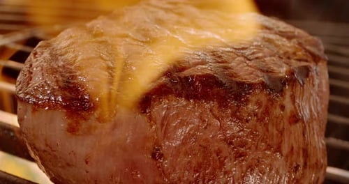 Juicy Steak Sizzles on Grill Close Up