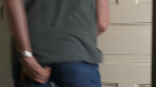 Man in jeans runs into toiled holding his butt, slam the door. Close up shot