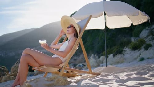 Lady Drinking Cocktail Beach Relaxing at Lounger in Straw Hat Elegant Woman