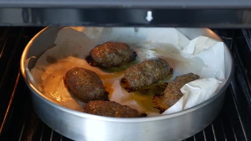 Meatballs on a baking sheet are baked in the oven