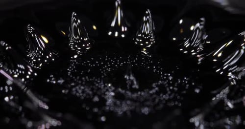 Ferrofluid Tinted with Colored Paints The Surface of the Black Liquid Abstract Background