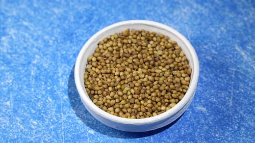 Coriander seeds are kept in a bowl.
