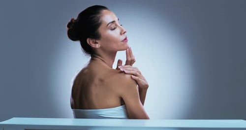 Woman with Bare Shoulders Touches Face, Beauty Portrait