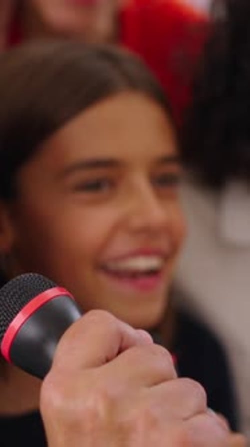 Group Sings Energetically with Microphones in Vertical Video