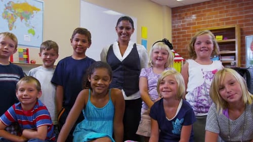 Enthusiastic Students Pose in Elementary School Classroom