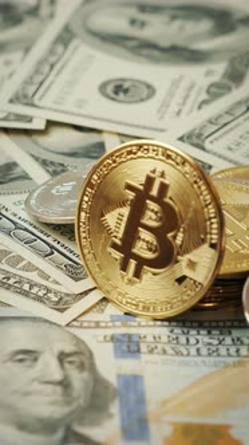 Bitcoin rotating on background of 100 hundred us dollar banknotes.Vertical video