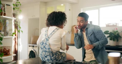 Father and Child Playfully Interacting in Kitchen