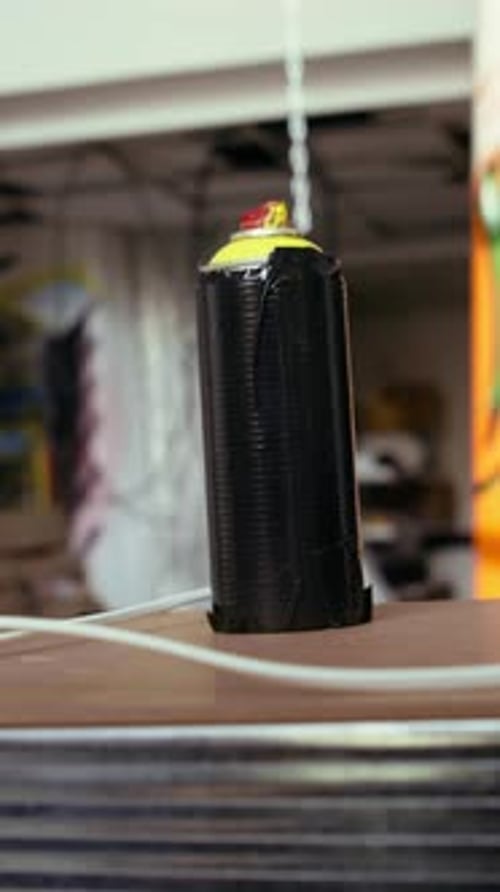 Vertical Video Close Up of Spray Cans in Empty Basement with Graffiti Drawings