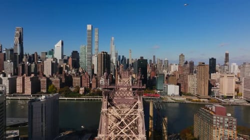 Aerial View Above Queensboro Bridge and Roosevelt Island Showcases East River Flowing Beneath