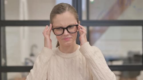 Portrait of Mature Business Woman with Headache in Office