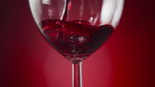 Dark Red Wine Pouring in a Glass Close Up