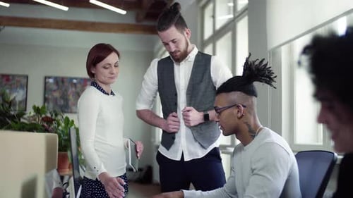 Group of Young Businesspeople Talking in Office, Start-Up Concept