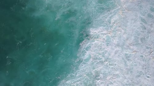 Aerial top down view of fresh and beautiful blue ocean water with small waves