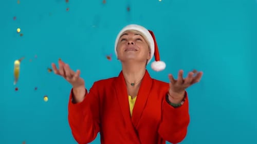 Happy Woman in Festive Mood Gold Tinsel is Falling Down to the Woman's Palm