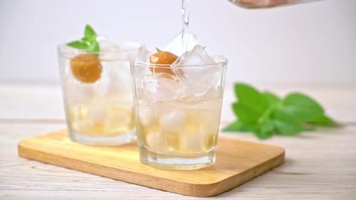 Preparing Refreshing Iced Drink with Mint and Fruit