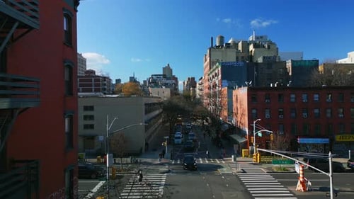 Aerial View of Cars Passing Through Road Intersection in Urban Neighbourhood