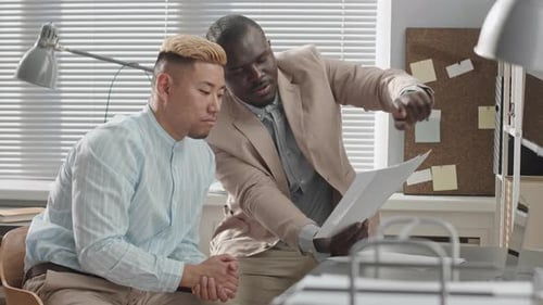 Multiracial Business Partners Having Discussion in Office