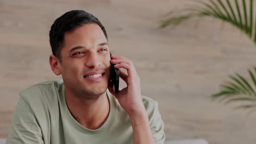 Man Talking on Phone Looking Cheerful Indoors