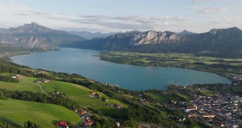 Houses Overlooking Tranquil Lake And Towering Mountains