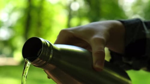 Closeup of Unrecognizable Female Hand Holding Water Bottle
