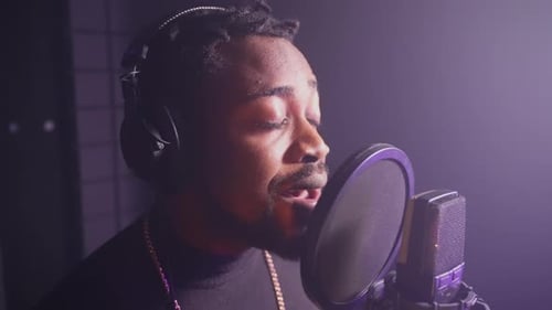 African American Male Singer Recording New Love Song in Music Studio